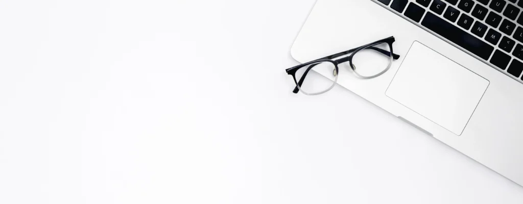 laptop glasses white background top view